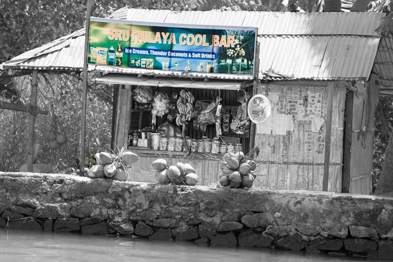 Living Below the Sea Level - local kiosk selling eatables, drinks, fruits and tobacco along an embankment in Alappuzha district, Kerala